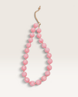 House of Holabox Sunday Best necklace featuring smooth marbled lolly pink resin beads and an adjustable gold chain.