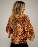 Odette ruffle blouse in a sheer, lightweight animal print with delicate ruffle trim and included camisole.