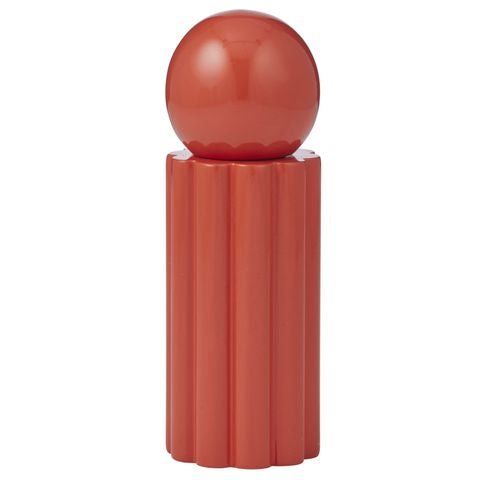 Red cylindrical object with a spherical top on a white background