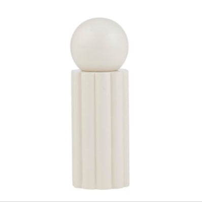White spherical object on a rectangular base against a white background