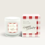 Palm Beach Collection Happy Birthday scented soy candle in a glass jar with matching pink gingham gift box.