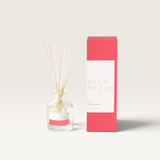 Palm Beach Collection Posy mini reed diffuser in a clear glass bottle with wooden reeds and pink branded packaging.