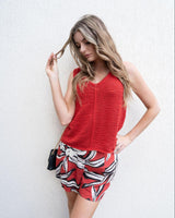 Woman wearing Anella printed viscose-linen shorts with a flat front and side pockets paired with a red knit tank top.