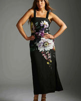 Model wearing a black cotton-nylon Providence midi dress with a square neckline and bold floral print.