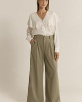 Olive green relaxed-fit trousers with pleat front detailing, side pockets, and a structured silhouette.