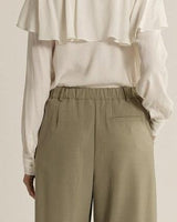 Back view of olive green relaxed-fit trousers with an elasticated waist and tailored pocket detail.