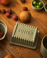 Robert Gordon stoneware butter dish with green reactive glaze and leaf design