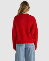 Back view of a soft, fluffy red oversized knit sweater with dropped shoulders and a ribbed neckline.