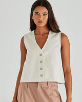 Off-white cotton denim vest with a V-neck, princess seams, and a classic front shank button closure.