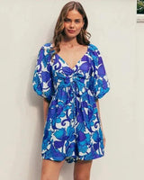 Blue and white floral print playsuit with V-neck, puff sleeves, and adjustable tie bust detail.