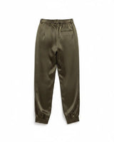 Back view of high-rise pesto green satin pants with a gathered blouson leg and cuffed ankles.