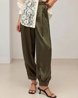 High-rise pesto satin pants with a gathered blouson leg, cuffed ankles, and side pockets.