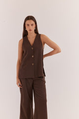 Dark brown Nevra Side Panel Vest featuring a V-neck, button-up front, and sleeveless design on a model.