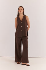 Nevra Side Panel Vest in dark brown with a V-neck, button-front closure, and side panel detailing.