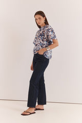 Anika Frill Neck Blouse in a blue abstract print with a high gathered neckline and short sleeves.