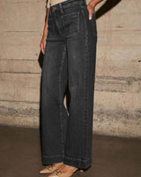 Mid-rise black straight leg denim jeans with front patch pockets and a button zip fly closure.