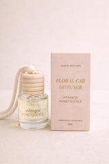 Soaked Body Bar floral car diffuser hanging on rear-view mirror with wooden lid and dried florals