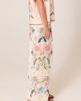 Wide-leg viscose-linen pants in a soft pink floral print with a contrast border hem and elasticated waistband.