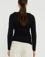 Back view of a black long-sleeve Sophia twisted top in stretch jersey with a side knot detail and boat neckline.