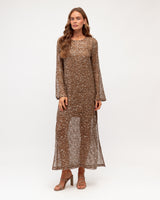 Cocoa-colored open weave mesh maxi dress with shimmering sequins and a slip lining, worn with neutral heeled sandals.
