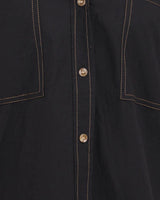 Black 100% cotton short sleeve shirt featuring contrast stitching, a button-down front, and two chest pockets.