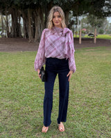 Model wearing dark blue straight-leg stretch jeans with a mid-rise fit and a soft cotton blend fabric.