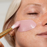 Facial mask, Stray Willow Pink Vitamin C, applied as a smooth pink clay layer with a brush to the cheek