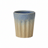 Ceramic cup with blue and beige gradient on a white background