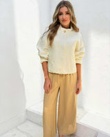 Woman wearing beige Sutton wide-leg pants with an elasticated waistband and soft, drapey fabric.