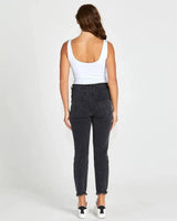 Back view of charcoal black mid-rise slim fit jeans with distressed frayed hems worn with a white tank top.