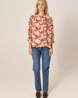 Sweet Emotions floral print long sleeve top with stand collar, balloon sleeves, and button-down front.