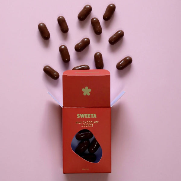 Red box labeled 'SWEETA' with chocolate candies on a pink background