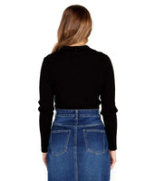 Back view of a woman wearing a black long-sleeve rib knit sweater with a Johnny collar and a blue denim skirt.