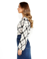 Model wearing a long-sleeve, high-neck Valentina bias blouse in a black and white plaid cotton-viscose fabric.