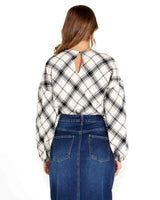 Back view of a black and white plaid Valentina bias blouse with long sleeves, high neckline, and a keyhole button back.