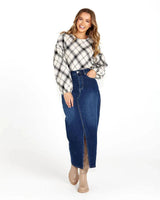 Woman wearing a long-sleeve, high-neck Valentina bias blouse in a black and white plaid cotton-viscose blend.