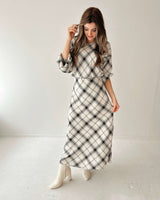 Woman wearing a long-sleeve, high-neck Valentina bias blouse in a white and black plaid cotton-viscose blend.