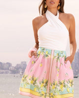 White cotton-blend Veronica twist-front halter top featuring a flattering sleeveless silhouette.