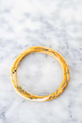 Colorful handmade wave resin stacking bangles in assorted colors arranged for stylish layering