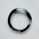 Colorful handmade Wave Resin Stacking Bangles in assorted colors and textures layered on wrist