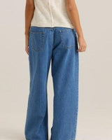 Back view of Yara wide-leg blue denim jeans featuring a relaxed fit, functional back pockets, and soft cotton-lyocell fabric.