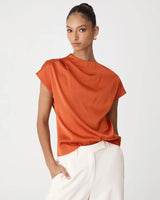 Burnt orange pleated draped top with cap sleeves in a lightweight, silky fabric.