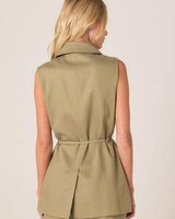 Back view of a sleeveless olive green Zephyr wrap vest with a notched lapel and a slim self-tie waist belt.