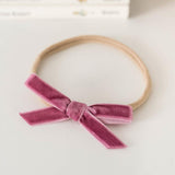 'Snuggle Hunny' Velvet Baby Headbands - Assorted Colours 
The Snuggle Hunny petite bow is made from velvet and the headband is made from soft stretch nylon elastic. 
One Size Fits All
(This is not a toy. Use only under adSnuggle Hunny