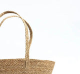 Amalfi Seagrass Tote basket with woven natural fibers and handles against white background